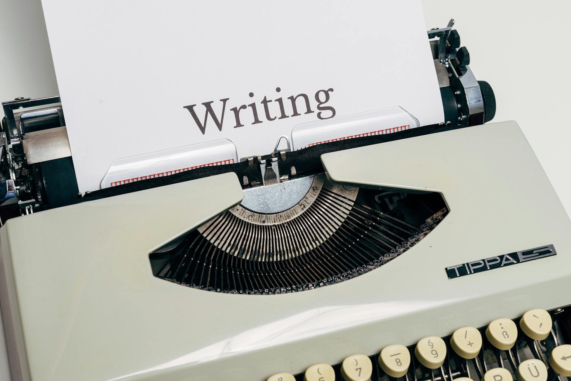Classic vintage typewriter displaying the word 'Writing' on a sheet of paper.