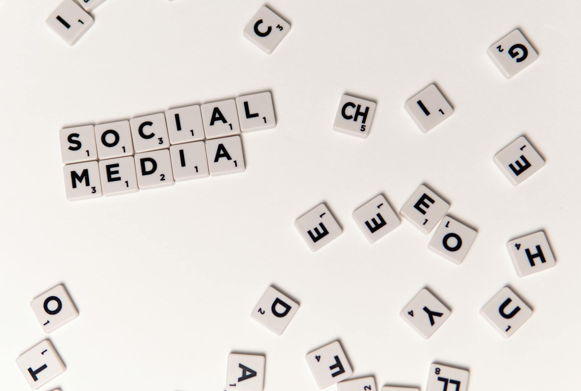 Scrabble tiles spelling 'Social Media' on a white background, symbolizing digital communication.