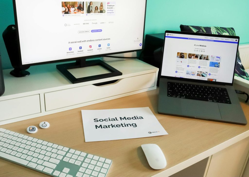 Stylish workspace with laptop and monitor for social media marketing.