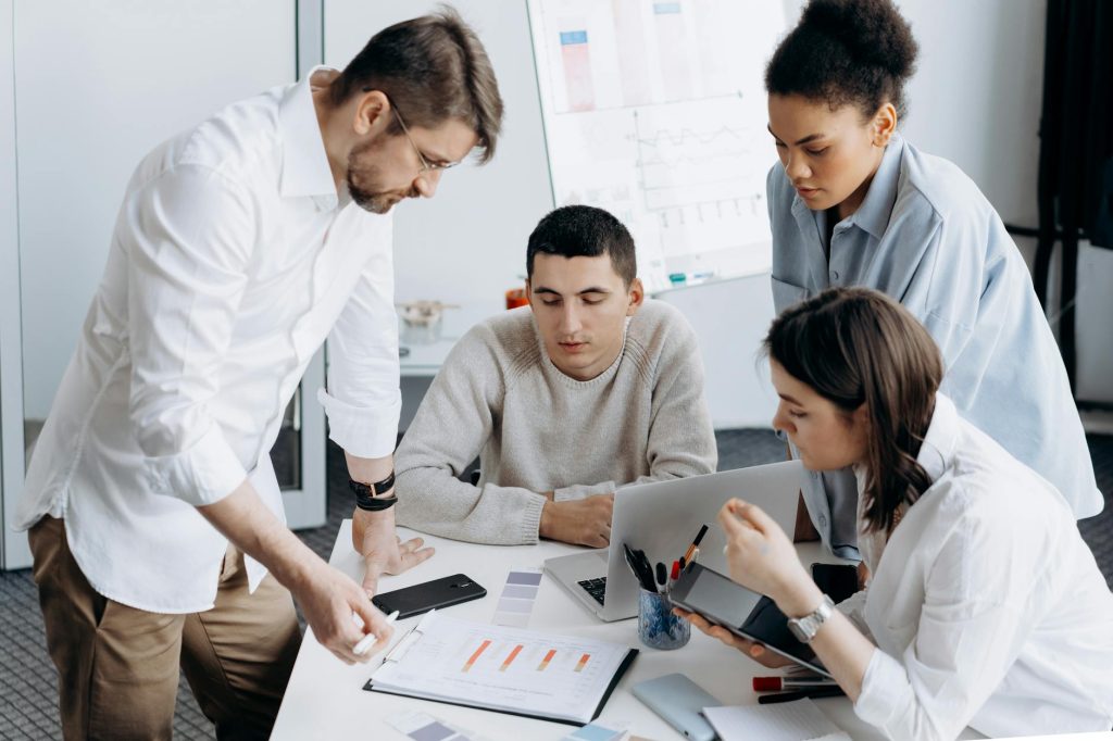 A group of professionals brainstorming and working together in a contemporary office setting.
