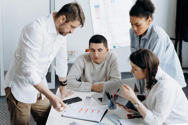 A group of professionals brainstorming and working together in a contemporary office setting.